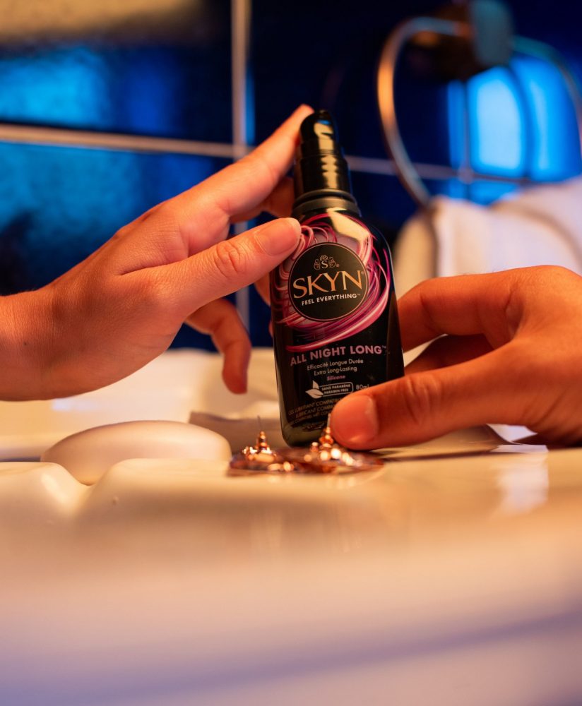 Boy and girl hands holding a SKYN All Night Long lubricant Boy and girl hands holding a SKYN All Night Long lubricant